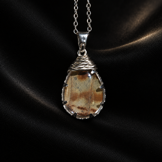 Real Morpho Butterfly Wing Teardrop Necklace, Sterling Silver Hypoallergenic Gift — detail view on a dark studio background