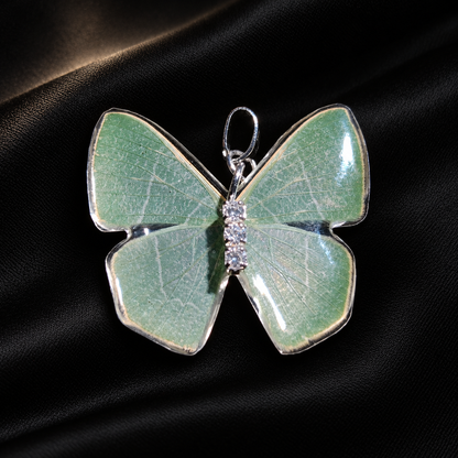 Real Green Moth Wing Necklace, Resin Pendant, Adjustable Sterling Silver Chain, Fairycore Gift — detail view on a dark studio background