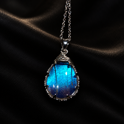 Real Morpho Butterfly Wing Teardrop Necklace, Sterling Silver Hypoallergenic Gift — detail view on a dark studio background