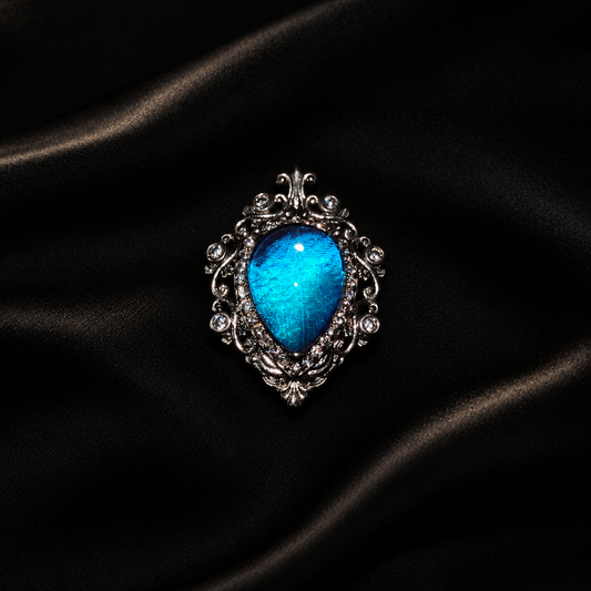 Iridescent Blue Morpho Butterfly Wing Necklace | Silver Shield Jewelry — detail view on a dark studio background