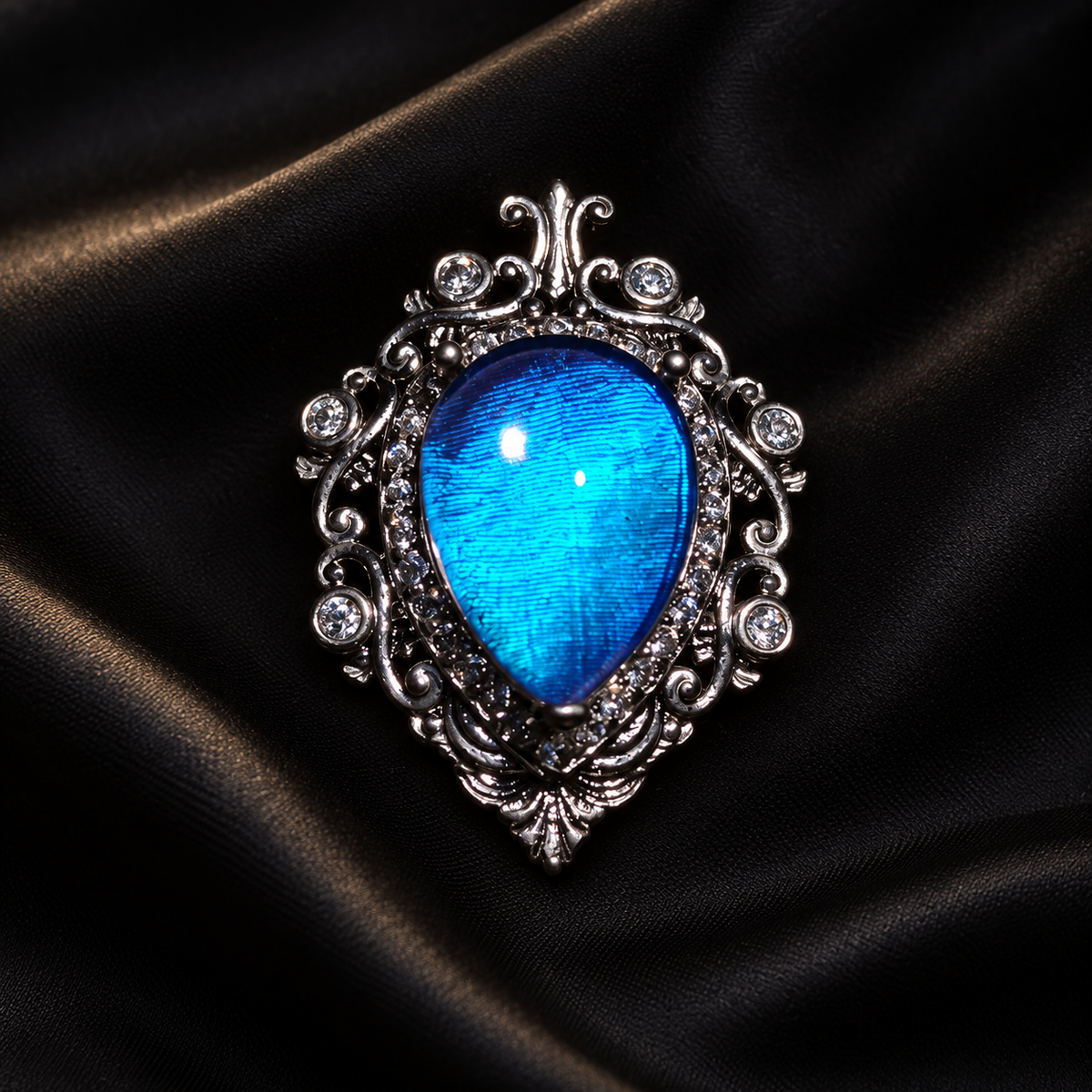 Iridescent Blue Morpho Butterfly Wing Necklace | Silver Shield Jewelry — detail view on a dark studio background