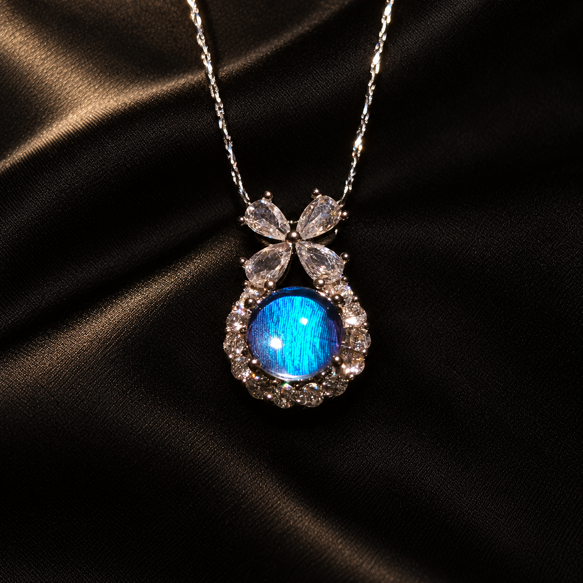 Blue Morpho butterfly wing bow necklace — black satin setting; styling props not included