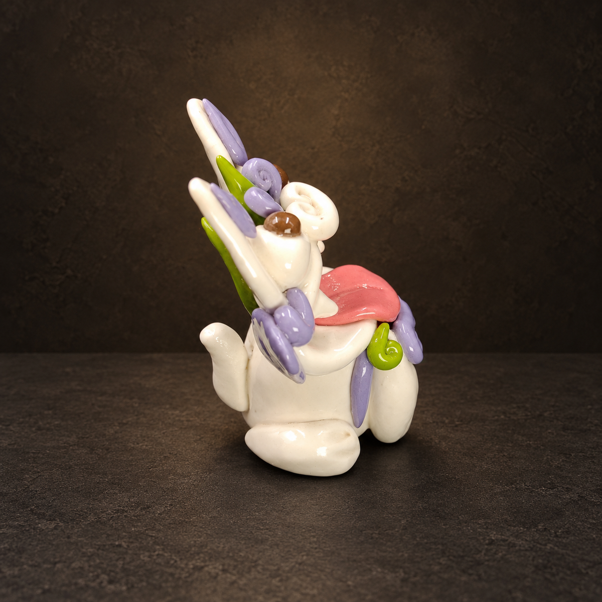 Ceramic Cat Figurine, Chinese Wamao Guardian, Colorful Yunnan Folk Art Decor — side view on a dark studio background