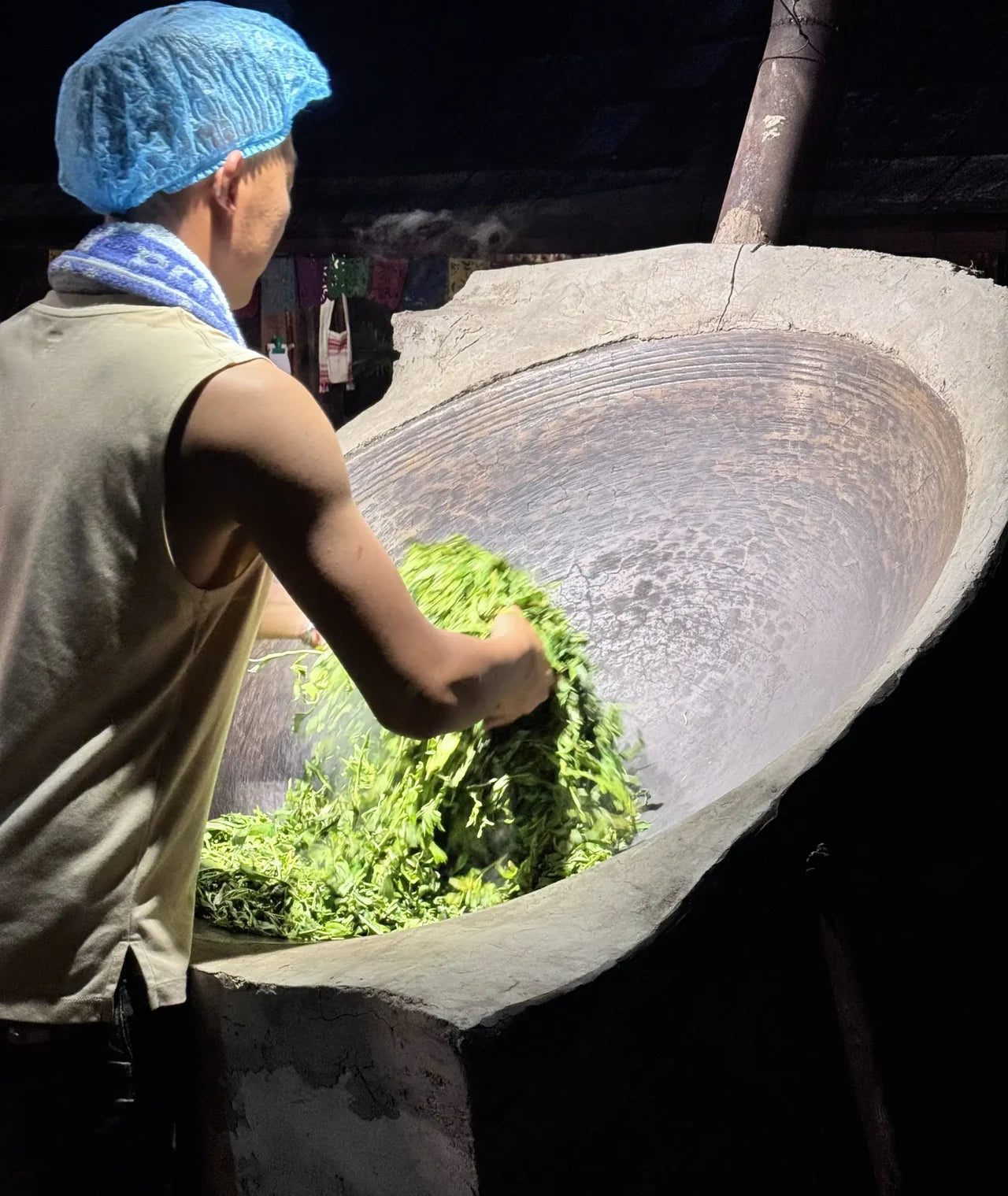 Pan-processing tea leaves in Jingmai